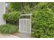 Backyard gate surrounded by lush greenery and foliage at 826 Rushing, Pittsboro, NC 27312