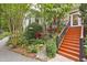Charming backyard featuring lush greenery, beautiful landscaping and wooden staircase at 826 Rushing, Pittsboro, NC 27312