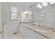 Bathroom with double granite vanity, modern lighting, and access to shower and toilet at 826 Rushing, Pittsboro, NC 27312