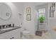 Well-lit bathroom with a vanity, framed mirror, toilet and a combination shower and tub at 826 Rushing, Pittsboro, NC 27312