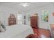 Bedroom with ceiling fan, hardwood floors, bright light, and closet access at 826 Rushing, Pittsboro, NC 27312