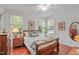 Charming bedroom featuring hardwood floors, natural light, and cozy furnishings at 826 Rushing, Pittsboro, NC 27312