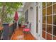 Cozy deck featuring outdoor seating, a red umbrella and views of the surrounding greenery at 826 Rushing, Pittsboro, NC 27312