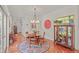 Dining area with glass table, 4 chairs, and red accent clock overlooking the kitchen at 826 Rushing, Pittsboro, NC 27312