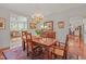 Dining room with a wooden table, chandelier, and access to a sunroom at 826 Rushing, Pittsboro, NC 27312
