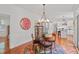 Breakfast room with a glass table, 4 chairs, and large clock overlooking the kitchen at 826 Rushing, Pittsboro, NC 27312