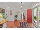 Spacious foyer with gleaming hardwood floors, a red front door, and elegant decor at 826 Rushing, Pittsboro, NC 27312