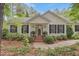 Charming home featuring a well-manicured lawn, black shutters, and brick stairs leading to the front door at 826 Rushing, Pittsboro, NC 27312