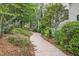 Landscaped pathway leading to the home with lush greenery and mulched garden beds at 826 Rushing, Pittsboro, NC 27312