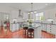 Updated kitchen features white cabinets, stainless appliances, island and adjacent breakfast room at 826 Rushing, Pittsboro, NC 27312