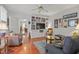 Cozy living room featuring hardwood floors, built-in shelving, ceiling fan and comfortable seating at 826 Rushing, Pittsboro, NC 27312