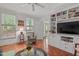 Bright living room with hardwood floors, built-in shelving, ceiling fan and multiple windows at 826 Rushing, Pittsboro, NC 27312