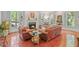 Cozy living room with a fireplace, leather sofas, and shuttered windows offering natural light at 826 Rushing, Pittsboro, NC 27312