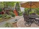 Outdoor patio with lush garden landscaping, a seating area and stairs to the deck at 826 Rushing, Pittsboro, NC 27312