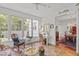 Sun room with wicker furniture, ceiling fan, and tile floors adjacent to dining room at 826 Rushing, Pittsboro, NC 27312