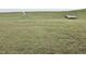 Large backyard with green grass and a white fence, offering ample outdoor space and privacy at 904 Romeria Dr, Durham, NC 27713