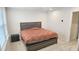 This primary bedroom boasts neutral walls, carpeted floor, and a modern gray platform bed at 904 Romeria Dr, Durham, NC 27713