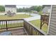 View from a wooden deck showcasing a manicured yard with a white privacy fence at 904 Romeria Dr, Durham, NC 27713