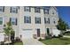 Townhomes with attached garages, landscaped lawns, and symmetrical design at 904 Romeria Dr, Durham, NC 27713