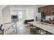 Open-concept living and kitchen area with stainless steel appliances and granite countertops at 904 Romeria Dr, Durham, NC 27713