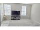 Bright living room with plush carpeting, modern TV, and plenty of natural light at 904 Romeria Dr, Durham, NC 27713