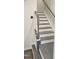 Staircase showing the gray stained wood treads and white risers and banister at 904 Romeria Dr, Durham, NC 27713