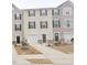 Charming townhomes featuring individual garages and matching front doors and trim details at 904 Romeria Dr, Durham, NC 27713