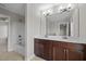 Bathroom featuring double sink vanity with dark wood cabinets, tile flooring, and tub with shower at 986 Gateway Commons Cir, Wake Forest, NC 27587