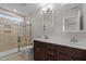 Bathroom featuring a glass shower, tile and double vanity with updated sinks and hardware at 986 Gateway Commons Cir, Wake Forest, NC 27587