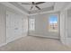 Bedroom with a ceiling fan, neutral colors, plush carpet and two windows at 986 Gateway Commons Cir, Wake Forest, NC 27587