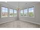 Bright room with multiple windows, a chandelier, and neutral walls at 986 Gateway Commons Cir, Wake Forest, NC 27587