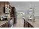 Modern kitchen featuring stainless appliances, granite countertops, and an island with a sink at 986 Gateway Commons Cir, Wake Forest, NC 27587