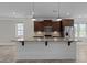 Kitchen featuring a large center island with a granite countertop, pendant lights, and stainless appliances at 986 Gateway Commons Cir, Wake Forest, NC 27587