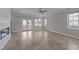 Open concept living room with neutral colors, lots of natural light, and sliding glass doors at 986 Gateway Commons Cir, Wake Forest, NC 27587