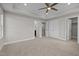 A spacious main bedroom with neutral tones, including three closets and ceiling fan at 986 Gateway Commons Cir, Wake Forest, NC 27587