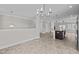 Open living space with modern lighting, kitchen island, and visible staircase at 986 Gateway Commons Cir, Wake Forest, NC 27587