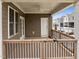 Exterior porch featuring natural wood railing, fan, and white door at 986 Gateway Commons Cir, Wake Forest, NC 27587