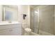 Bright bathroom features tiled shower with glass door and white vanity at 1009 Morrison Dr, Durham, NC 27703