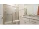 Well-lit bathroom featuring tiled shower with glass door and granite vanity at 1009 Morrison Dr, Durham, NC 27703