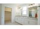 Bathroom featuring double vanity with granite countertop, walk-in shower, and a closet at 1009 Morrison Dr, Durham, NC 27703