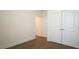 Bedroom with hardwood flooring, neutral walls, and double door access at 1009 Morrison Dr, Durham, NC 27703