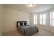 Sunlit bedroom with bay windows, a comfortable bed, and neutral decor at 1009 Morrison Dr, Durham, NC 27703