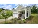 Inviting home featuring a cozy front porch with rocking chair and manicured landscaping at 1009 Morrison Dr, Durham, NC 27703