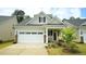 Charming home featuring a two-car garage, inviting front porch, and well-maintained landscaping at 1009 Morrison Dr, Durham, NC 27703