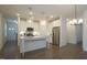 Bright kitchen with white cabinets, granite countertops, stainless steel appliances, and wood flooring at 1009 Morrison Dr, Durham, NC 27703