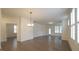 An open and airy living room space with an elegant chandelier and abundant natural light at 1009 Morrison Dr, Durham, NC 27703