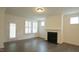 Cozy living room with fireplace, plantation shutters, and a glass door leading to the outside at 1009 Morrison Dr, Durham, NC 27703