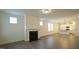 Living room showcasing a fireplace, multiple windows, and open layout leading into the kitchen at 1009 Morrison Dr, Durham, NC 27703