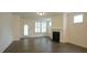 Bright living room with modern fireplace, wooden floors, and exterior door at 1009 Morrison Dr, Durham, NC 27703