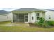 Back yard with screen patio and manicured landscaping offering a relaxing space at 1009 Morrison Dr, Durham, NC 27703